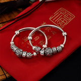 kali-paire-de-bracelets-de-cheville-bebe-argent-massif-mantra-tibetain-charms